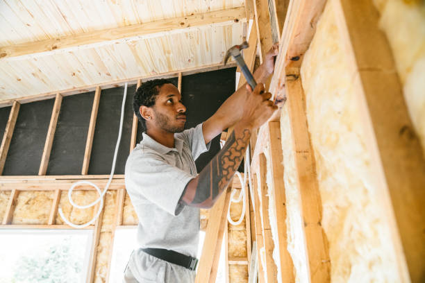 Man fitting insulation in frame